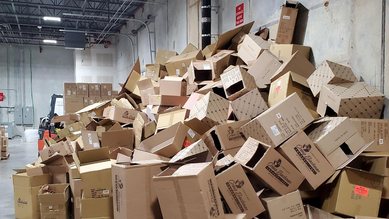 Warehouse full of empty cardboard boxes in a big pile